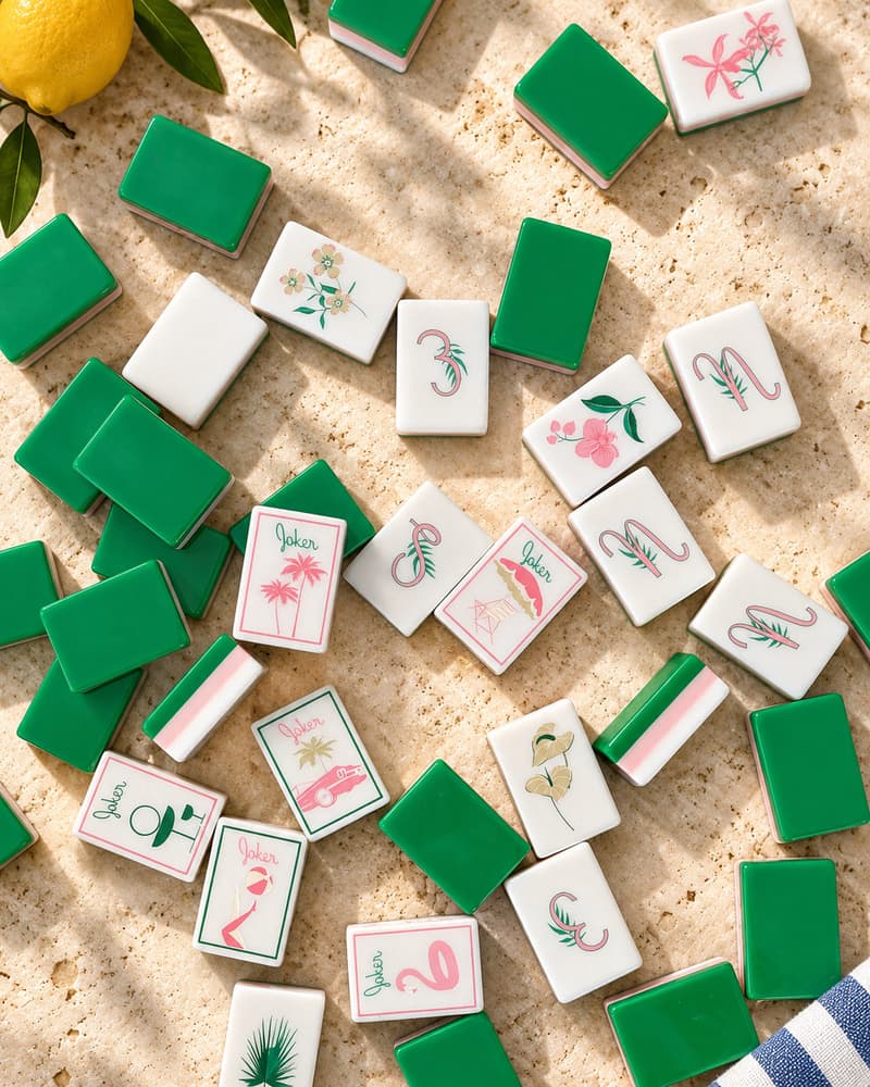 Flamingo Set tiles face up and face down beside lemons on a stone table