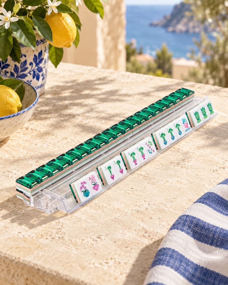 Giardino Set tiles with jewel-green backs standing in an acrylic rack by the sea