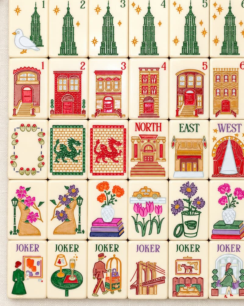 Close-up of Manhattan Set tile faces with towers, brownstones, flowers and city jokers