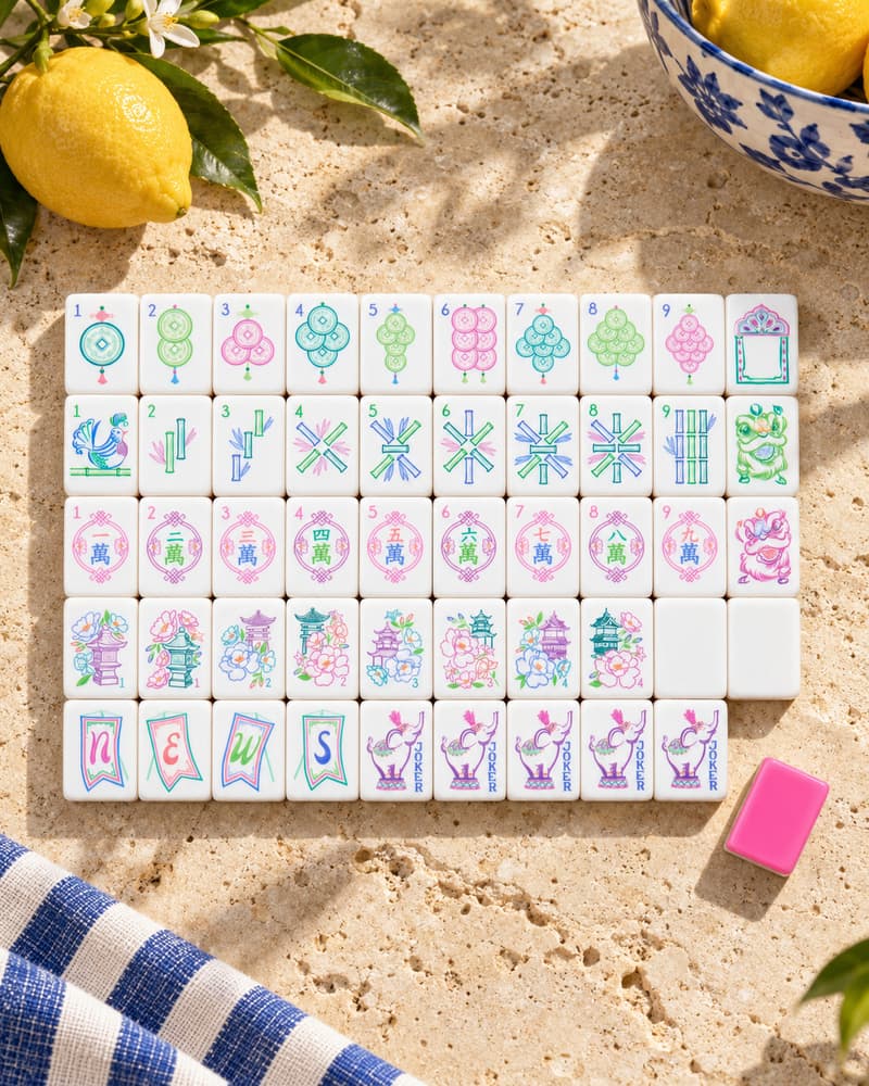 The Positano Set laid out in rows on a sunny stone table, with pink and green pastel faces