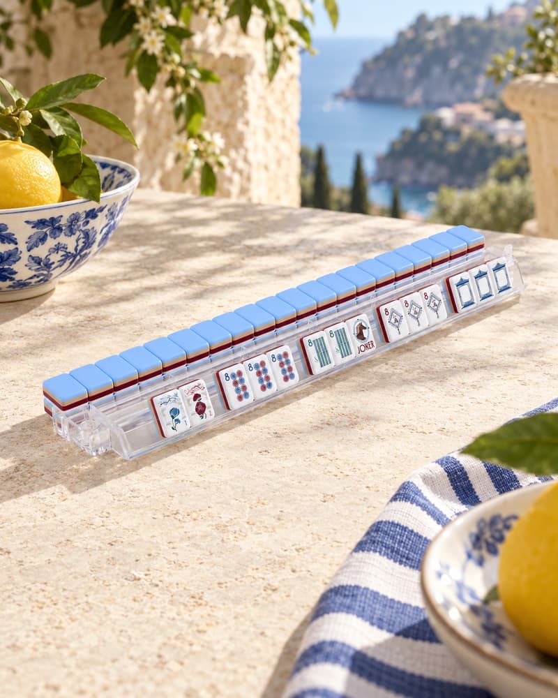 Riviera Set tiles standing in an acrylic rack on a terrace above the sea