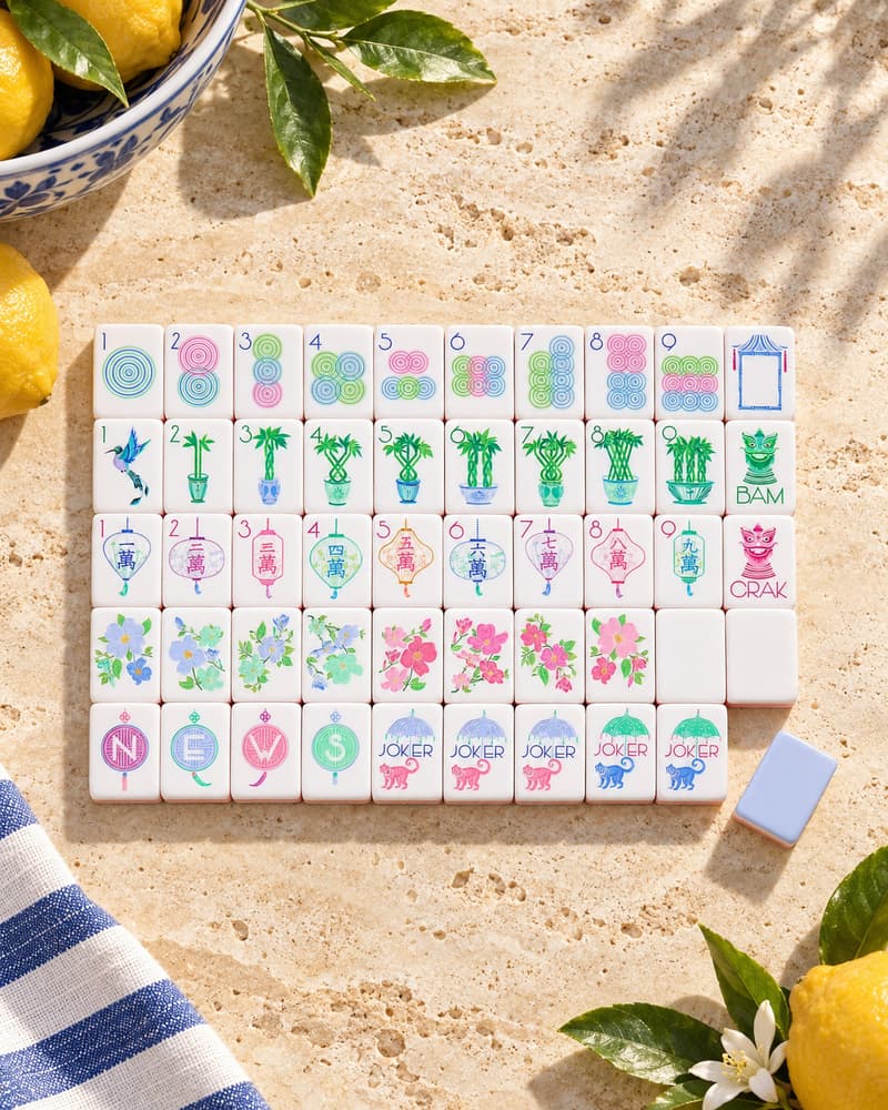 The Sorbetto Set laid out in rows on a sunny stone table, with rainbow pastel faces